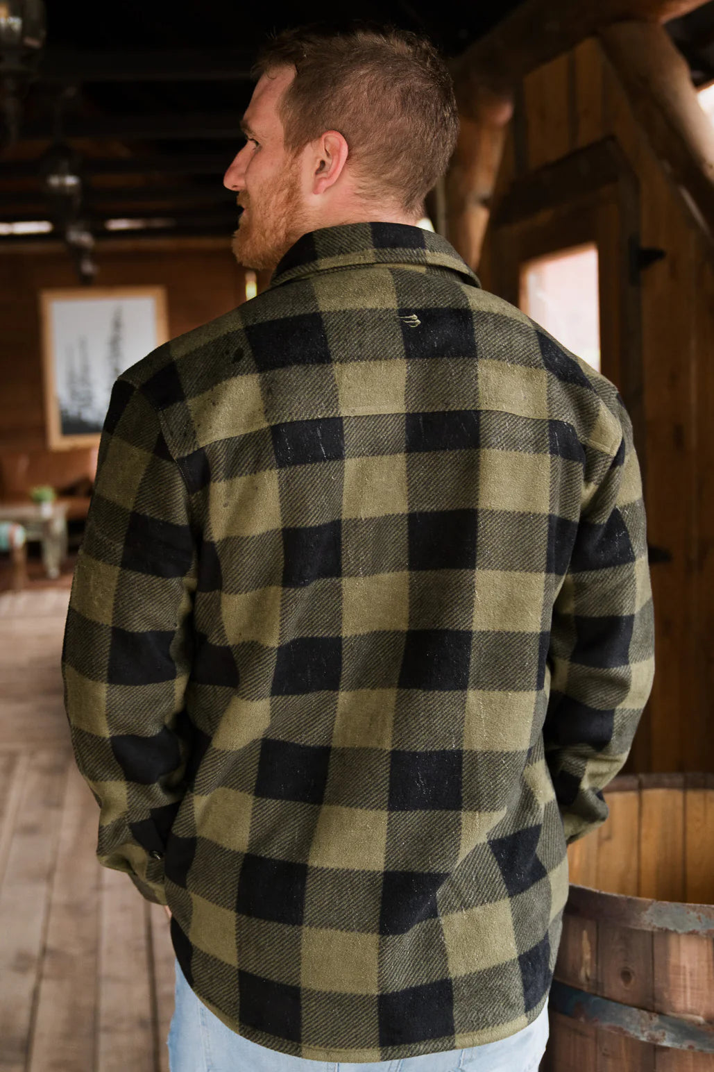 A green plaid shacket being worn by a Burlebo model with a Burlebo hat on.