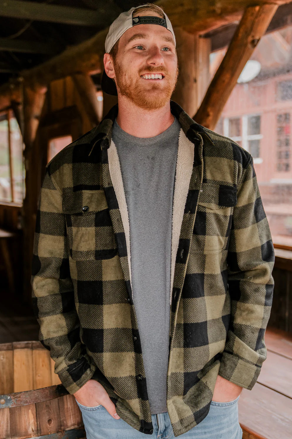 A green plaid shacket being worn by a Burlebo model with a Burlebo hat on.