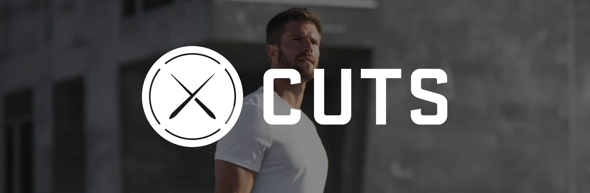 CUTS Clothing white logo with a model wearing a white CUTS t-shirt behind it.